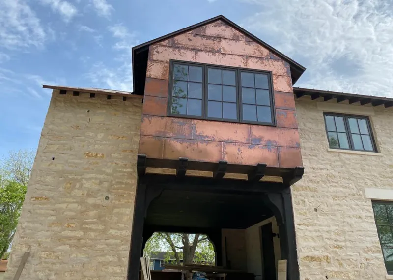 Copper metal panel facade on a stone building for Skylight Installation in Sellersburg