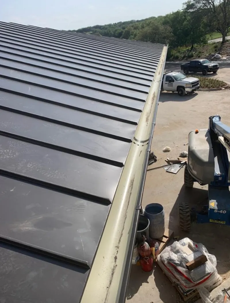 Standing seam panel and gutter detail on a metal roofing jobsite in Sellersburg